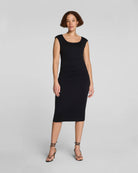 Woman wearing a black dress on a gray background