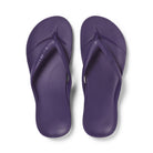 Pair of purple flip-flops on a white background