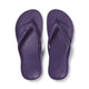 Pair of purple flip-flops on a white background