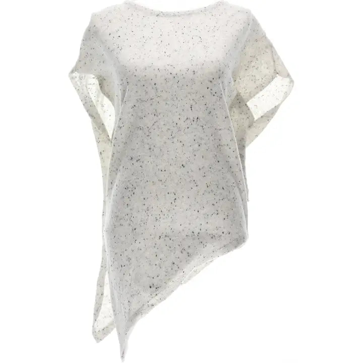 A loose-fitting, asymmetrical knit poncho top in a light cream or off-white color with small black speckles, shown against a plain white background.
