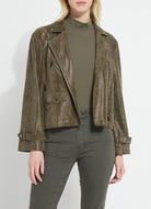 Person wearing a green textured jacket over a green turtleneck and pants on a white background