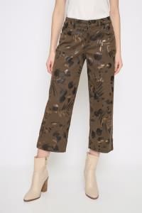 Person wearing brown floral-patterned pants on a white background