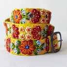 Colorful floral belt with a metal buckle on a white background