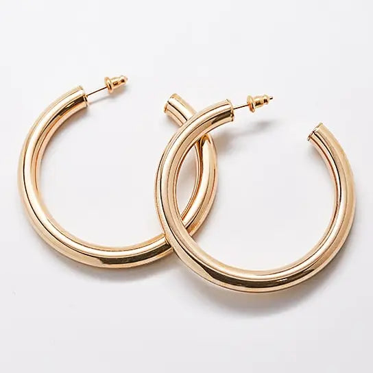 Pair of medium gold-tone hoop earrings on a light background