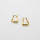 Pair of gold-tone triangle hoop earrings on a light background