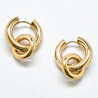 Gold interlocking hoop earrings on a white background
