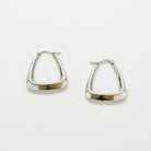 Pair of silver-tone triangle hoop earrings on a light background