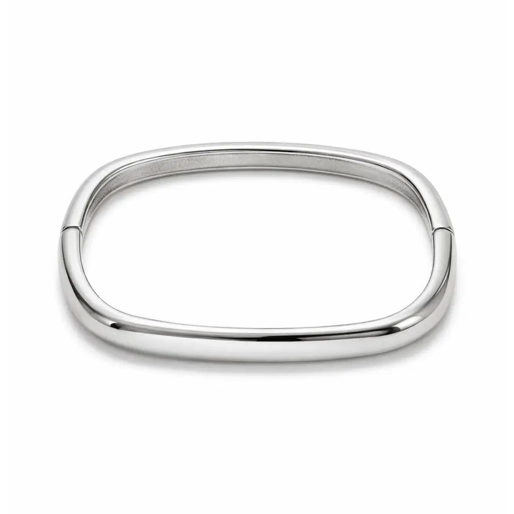 A polished silver-toned metal bangle bracelet with a rounded rectangular or egg-shaped profile, shown on a clean white background.