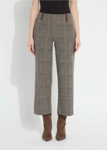 A woman modeling taupe plaid wide-leg cropped ponte trousers with brown suede ankle boots and a black top, against a light gray studio background.