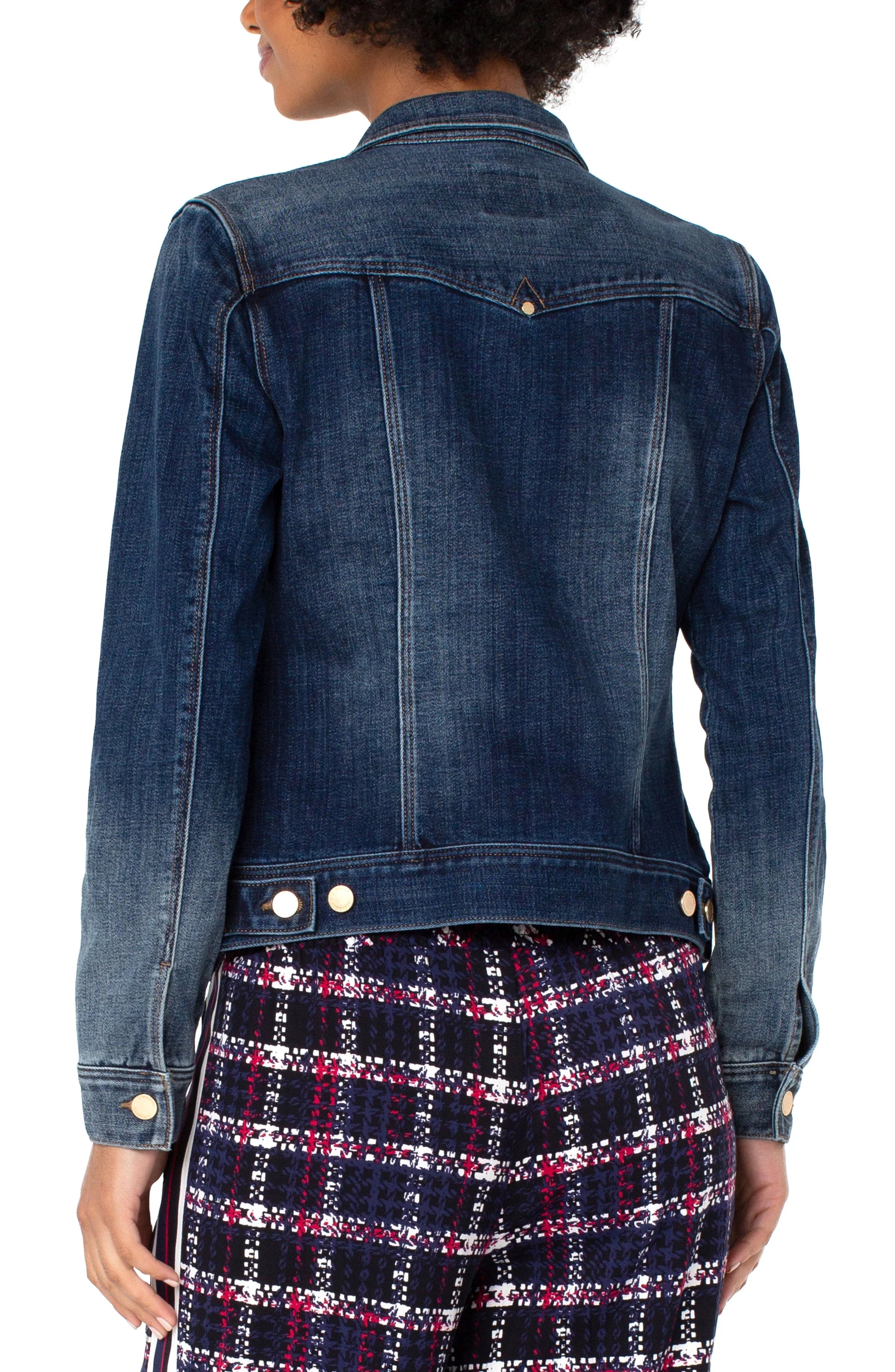 Denim jacket worn by a person on a white background