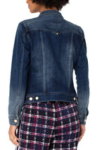 Denim jacket worn by a person on a white background