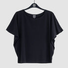 Black t-shirt on a hanger against a white background
