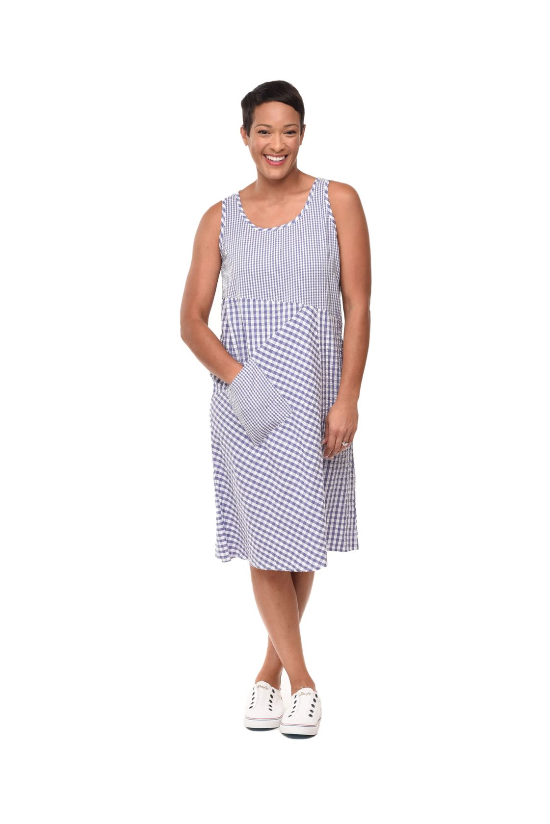 Woman wearing a blue and white checkered dress on a white background