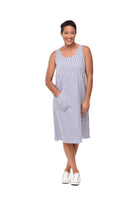 Woman wearing a blue and white checkered dress on a white background
