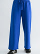 Blue pants worn by a person on a white background