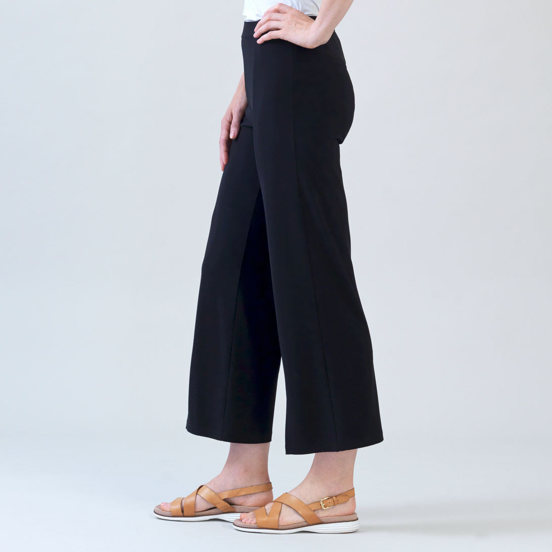 Alternate side view of the Clara Sunwoo black ankle pant showing the front slit