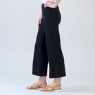 Alternate side view of the Clara Sunwoo black ankle pant showing the front slit