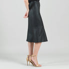 Side view of the Clara Sunwoo black flounce midi skirt