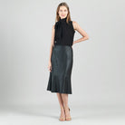 Clara Sunwoo black faux leather flounce skirt styled with a tucked top