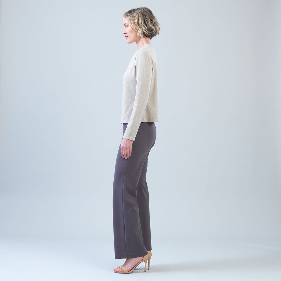 Side view of the Clara Sunwoo natural sweater showing the asymmetrical hem