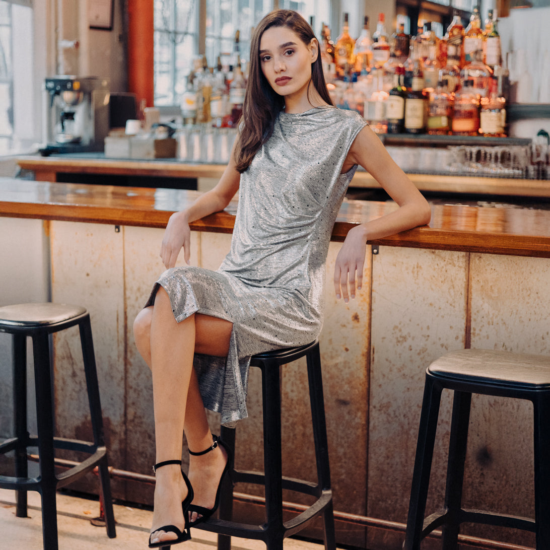 Model wearing the Clara Sunwoo silver shimmer dots midi dress, styled lifestyle view