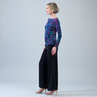 Side view of the Clara Sunwoo track stripe top showing the side ruching