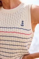 Close-up of a sleeveless knitted top with an anchor design.