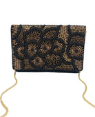 A black and gold beaded clutch bag with a geometric and floral pattern, featuring a gold chain strap, shown against a plain white background.