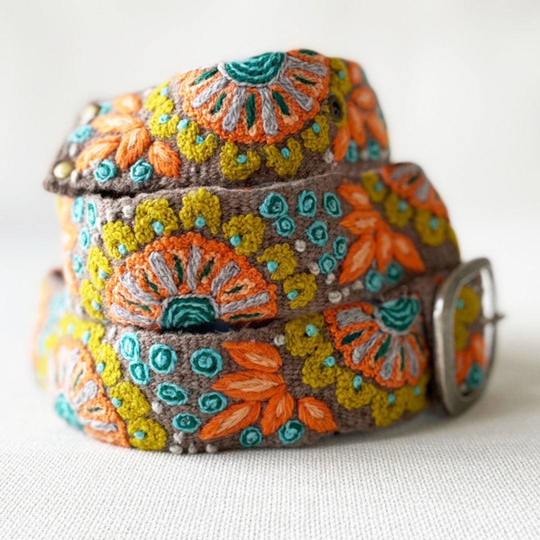 Decorative belt with floral patterns on a grey background