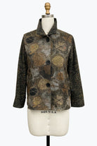 A women's long-sleeve button-front jacket displayed on a cream dress form mannequin. The jacket features a mixed abstract pattern with snakeskin-style brown and black patterns on the front panel and a solid black textured fabric on the sleeves.