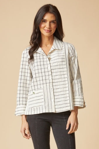 Woman wearing a plaid shirt with a beige background
