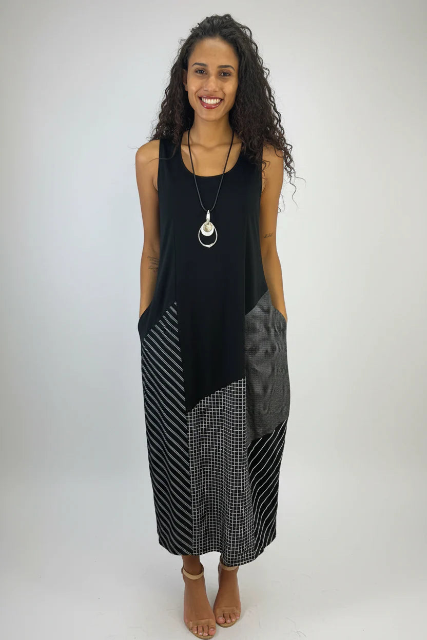 Woman wearing a black and gray dress with a white background