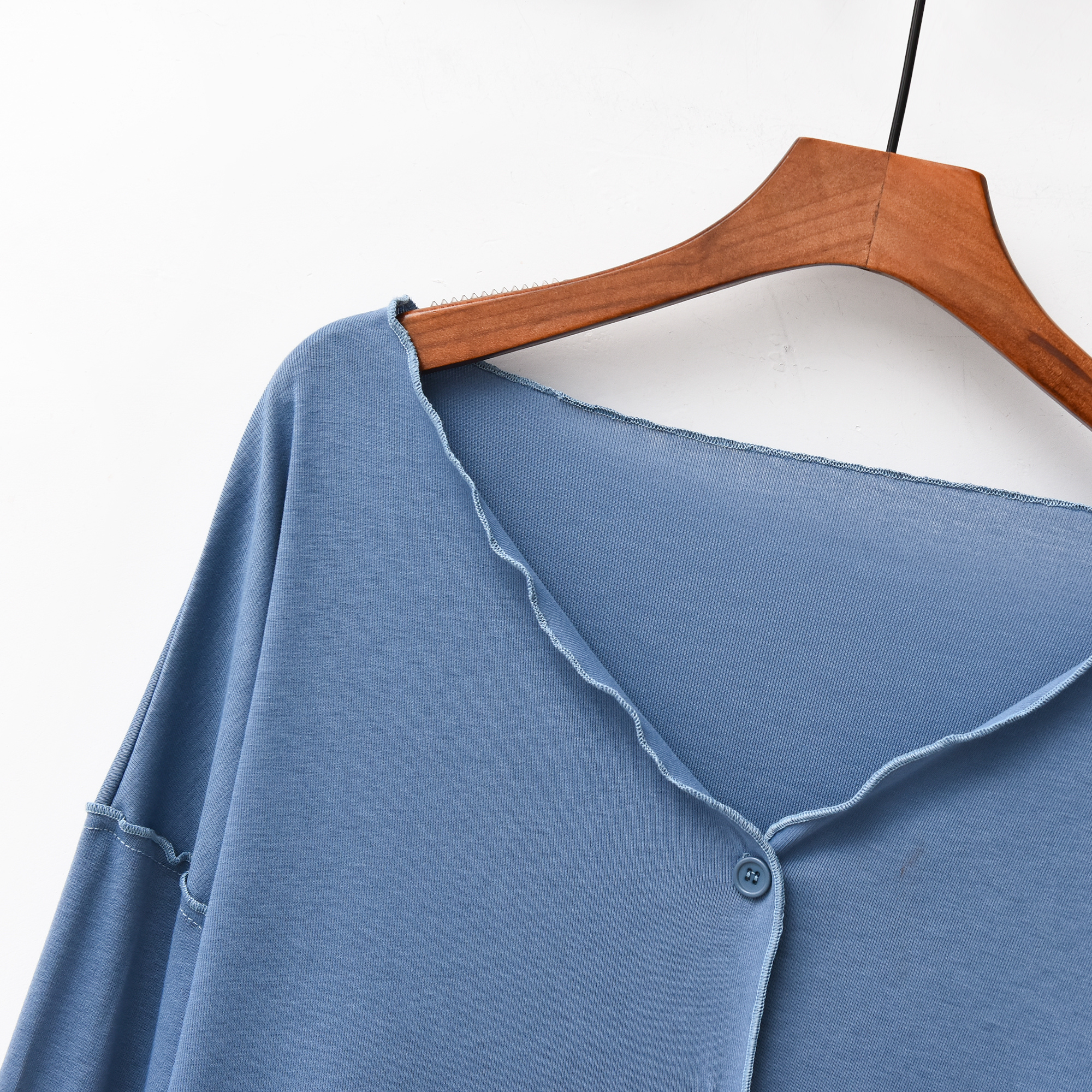 Close-up of the V-neck and button placket on the foggy blue modal top