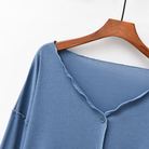 Close-up of the V-neck and button placket on the foggy blue modal top