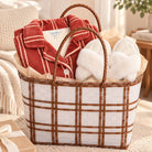 DrifWoo red stripe holiday pajamas and ivory fluffy slippers packed in a woven plaid gift tote