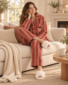 Woman relaxing by the fireplace in the red stripe fleece pajamas