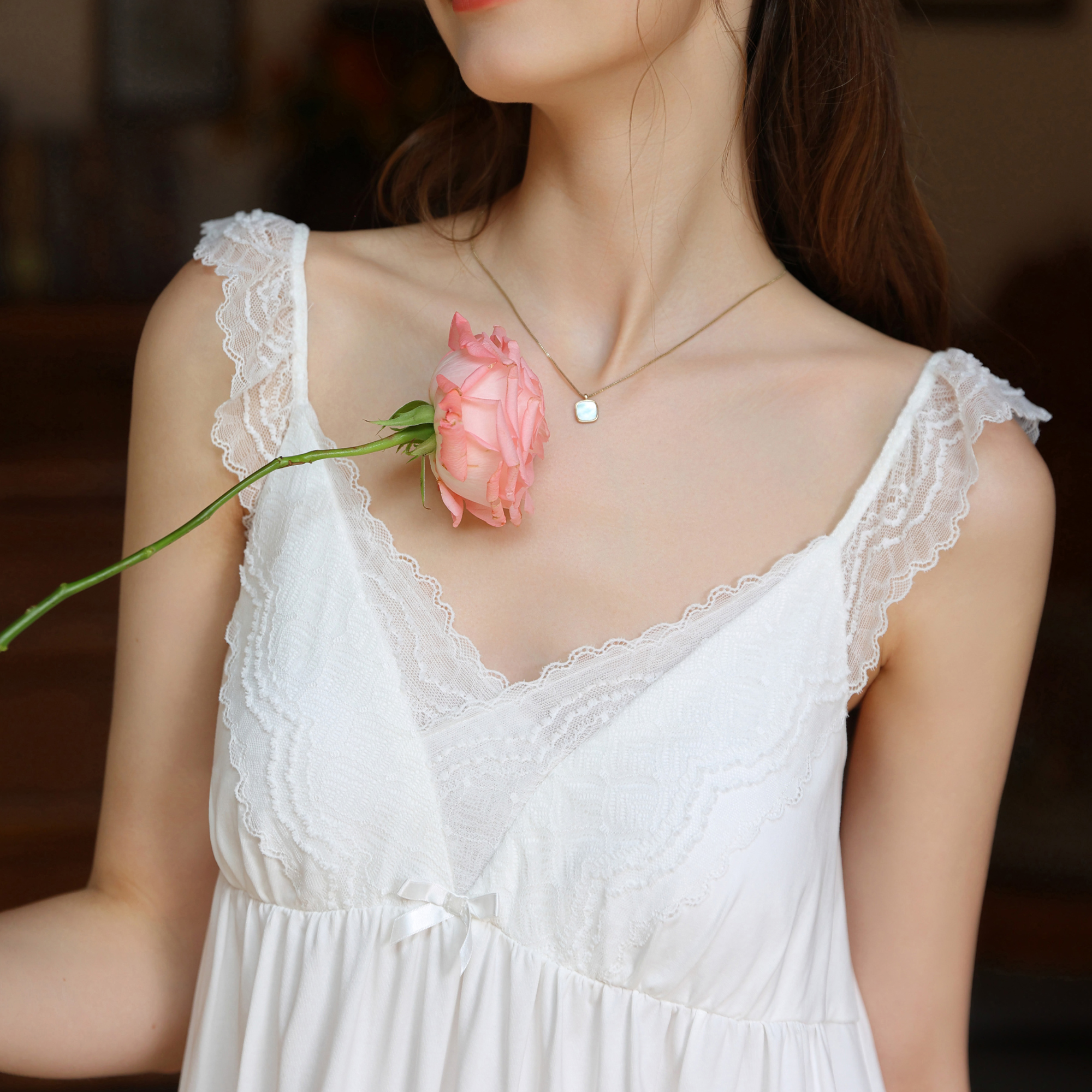 Lace straps and V-neckline on the white nightgown