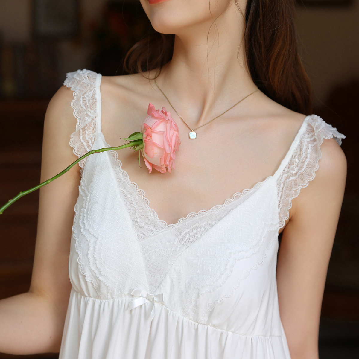 Lace straps and V-neckline on the white nightgown