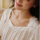 Floral lace detail on the square neckline of the white nightdress