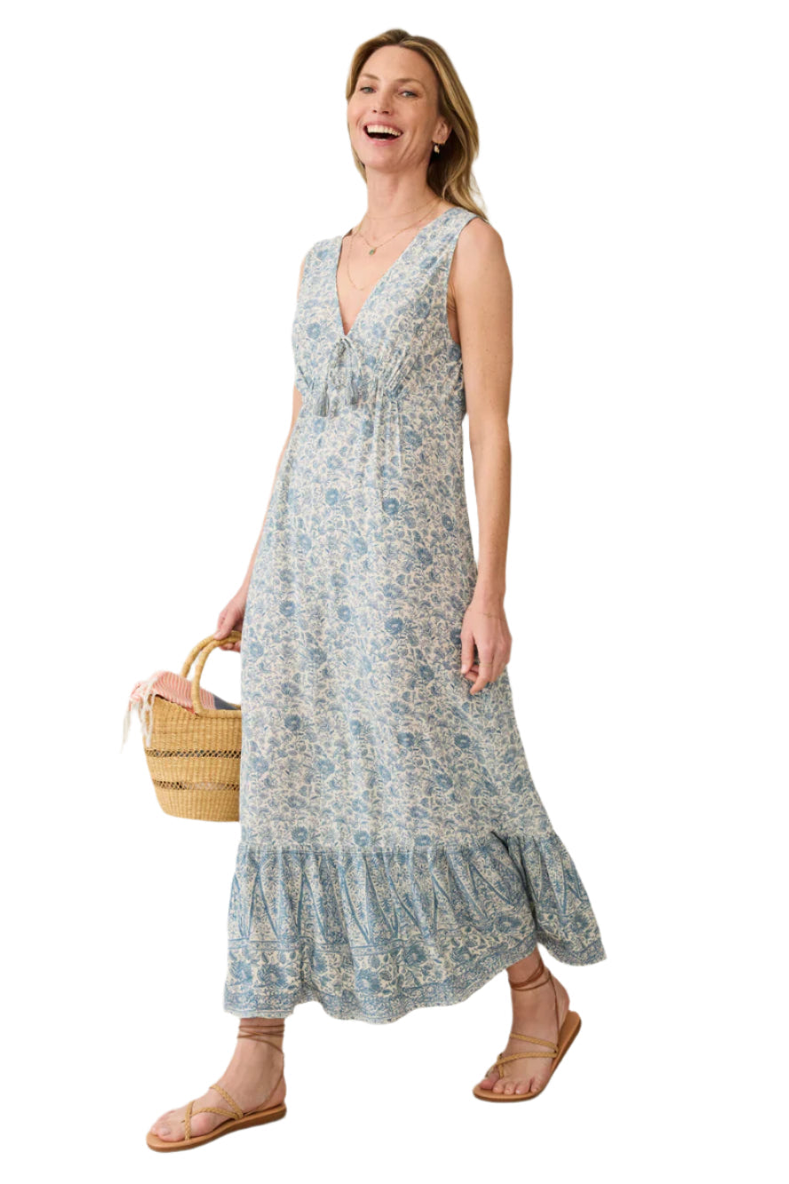 Faherty Eden Dress in blue floral print on ivory, tiered maxi with ruffled hem, side view walking