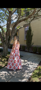 Faherty Voile Alexi Dress in Bloom Poem white with red and green floral print, flowing A-line maxi worn outdoors, back view