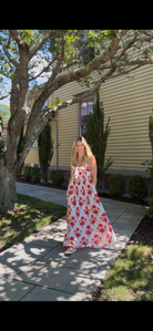 Faherty Voile Alexi Dress in Bloom Poem white with red and green floral print, flowing A-line maxi worn outdoors, front view