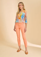 FDJ Olivia Slim Ankle jeans in cantaloupe, full-length view styled with a color block top