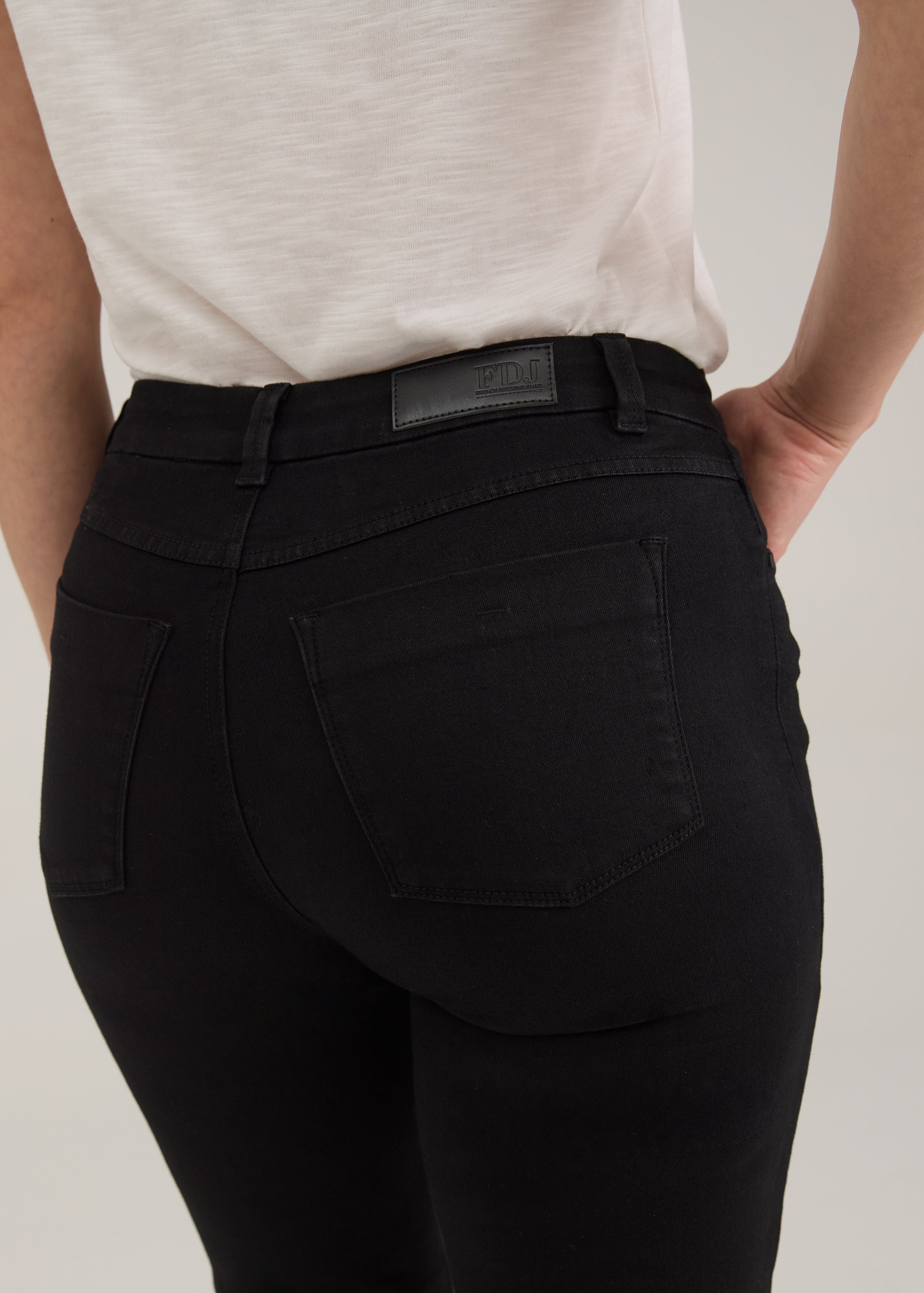 Close-up of FDJ Petite Olivia Straight Leg Jeans in black, back pocket and waistband detail