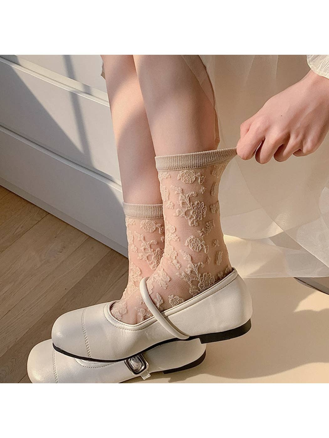 Sheer floral lace socks worn with white shoes