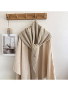Ivory cable knit triangle scarf hanging
