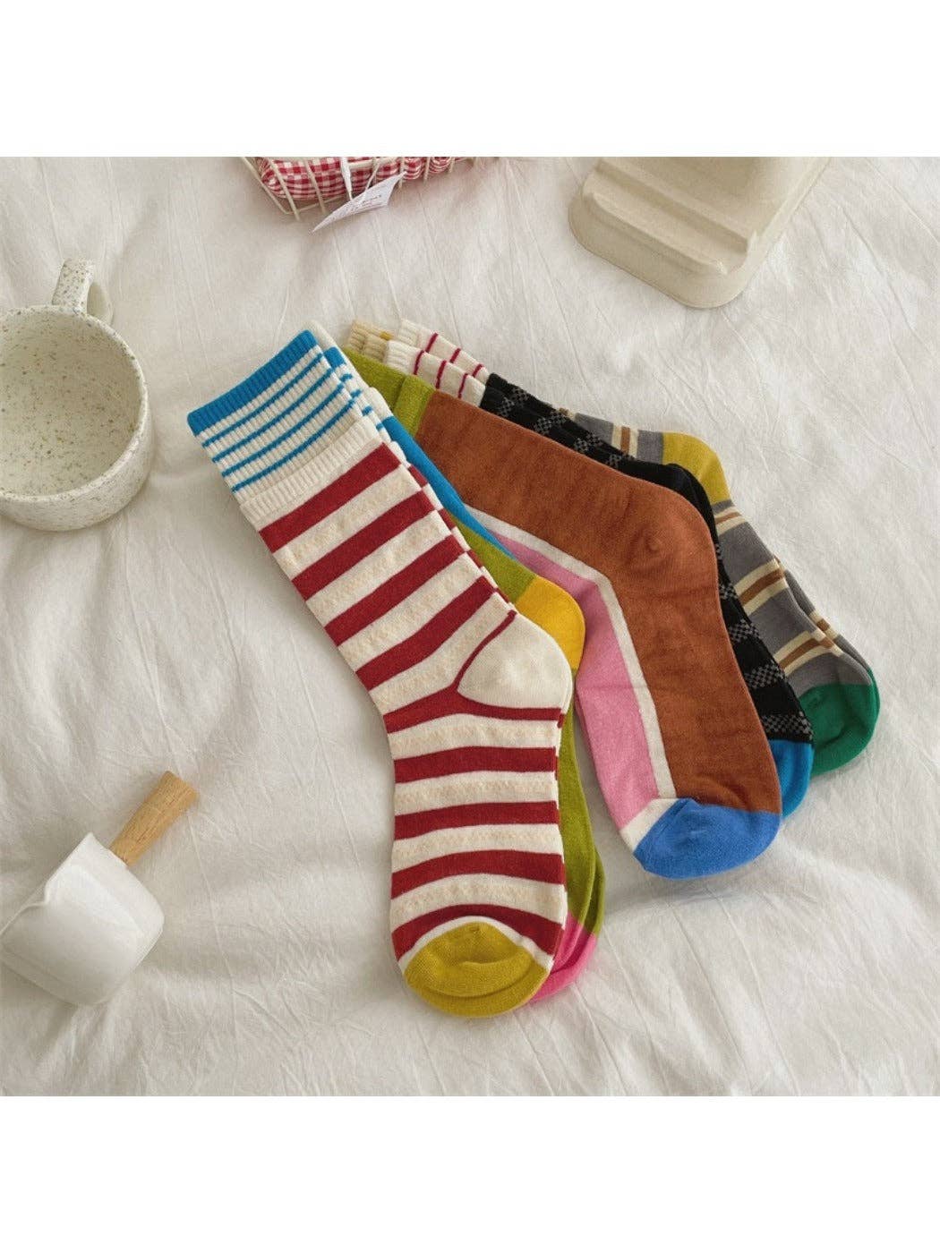 Patchwork stripe mid-calf socks laid out in assorted colors