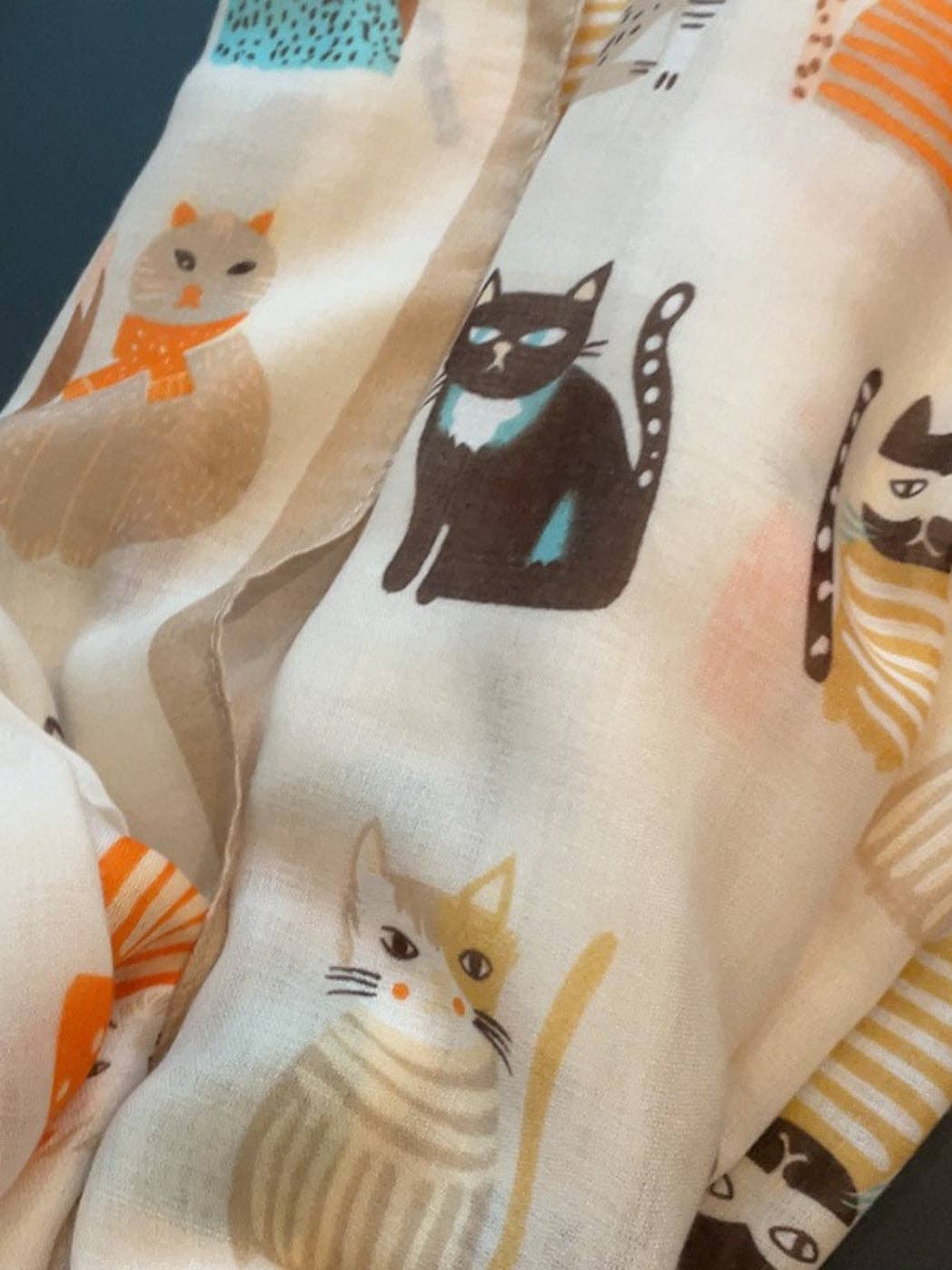 Close-up of a single illustrated cat on the scarf