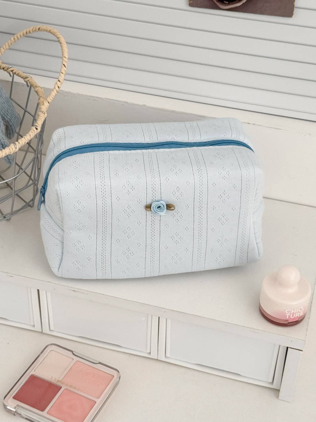Light blue textured cosmetic pouch with rose detail