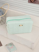 Mint green textured cosmetic pouch with rose detail